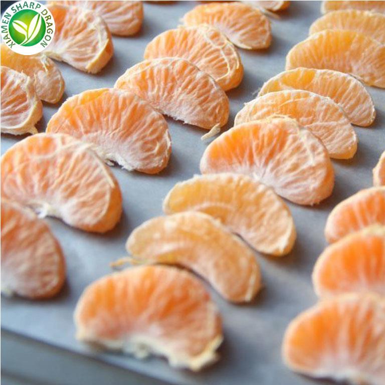 Peeled mandarin orange segments arranged for freezing